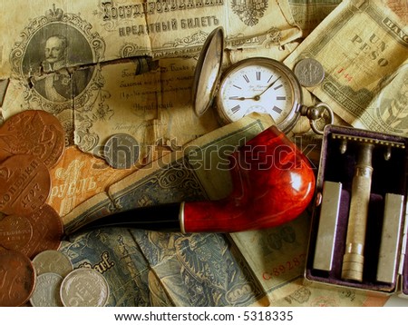 Pipe, old money, old clock and old razor