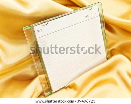 cd disc with blank cover over the gold background