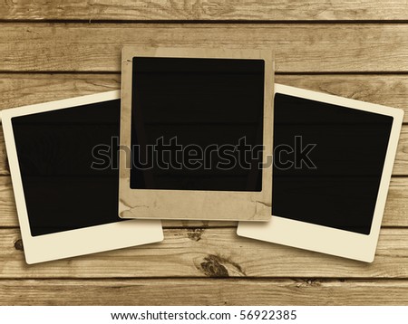three photo frames at wooden background