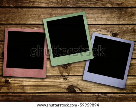 Photo of photo frames at abstract wooden background