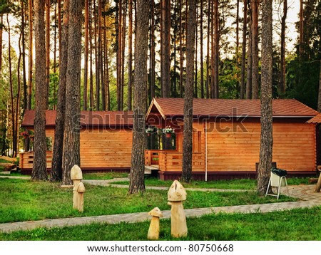 Two log House in the forest at the evening
