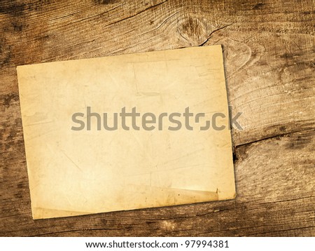 Sheet of paper over the wooden background
