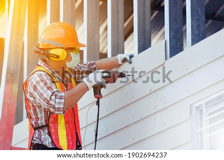Worker man with safety helmet Construction building industry, new home, construction interior service concepts - Selective focus.
vintage film grain filter effect styles
