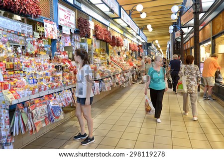 BUDAPEST, HUNGARY, JULY 10, 2015: People shopping inside Great Market Hall of Budapest, the largest and oldest indoor market in Budapest, located at the end of famous shopping street Vaci utca.