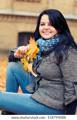 Young pretty woman in autumn park