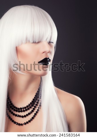 beautiful blonde woman with black make-up and accessories