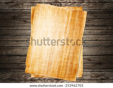 old papyrus paper on wooden background