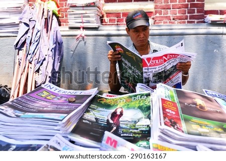 YANGON, MYANMAR - March 27, 2013 : Unidentified man is selling newspaper on the street in Yangon, Myanmar. Yangon is a former capital of Myanmar