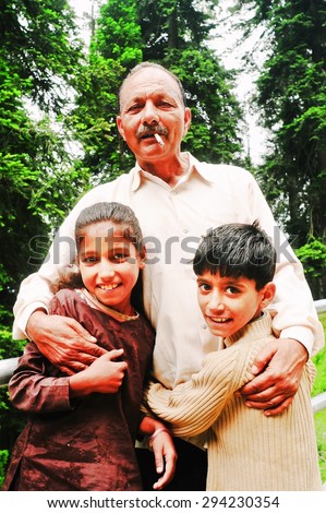 SRINAGAR, INDIA. JUNE 24, 2012 : The Indian family smile at national park in Srinagar, North of India