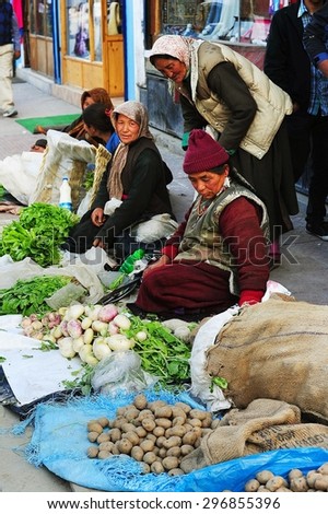 LEH, INDIA, JUNE 12, 2012 : Unidentified tibetan women selling potato and varity vegetables on downtown street at Leh, North of India