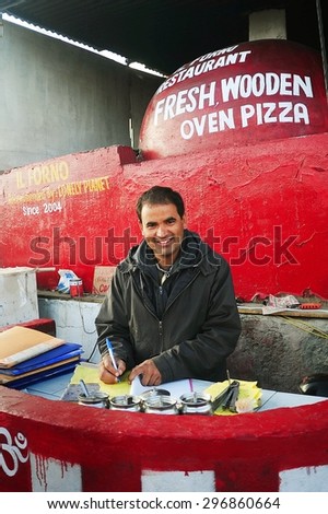 LEH, INDIA, JUNE 12, 2012 : Unidentified Indian man selling homemade pizza that baked by wooden stoves at Leh, North of India