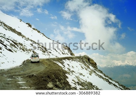 INDIA, LEH, JUNE14, 2012 : The car on himalayan high altitude road near Khardung La pass, highest road pass on world - Ladakh, Jammu and Kashmir, India