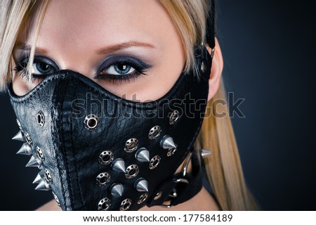 portrait of a woman slave in a mask with spikes
