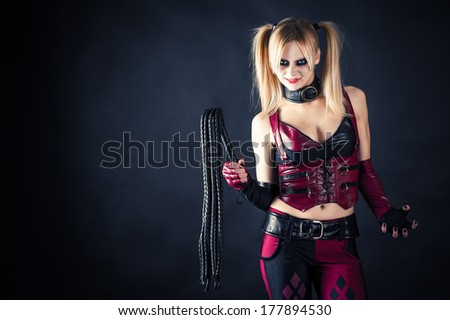woman with a whip in the image of a harlequin