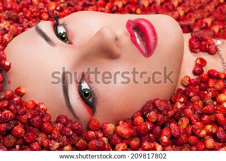 sensual beautiful female face in wild strawberry