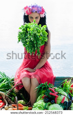 beautiful woman sitting on the edge of the boat with parsley in hand