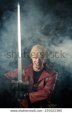 Portrait aggressive fantasy hero with sword in hand