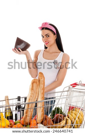 beautiful woman with a supermarket trolley and cheese in the hand