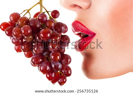 sexy woman eating red grapes, sensual red lips