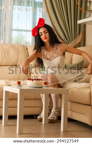 elegant woman in a white dress doll takes the cake with cherries