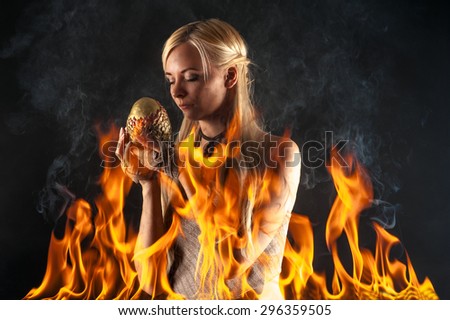 attractive woman with a dragon egg in the fire
