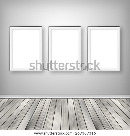 Gallery interior with three empty frames on wall.