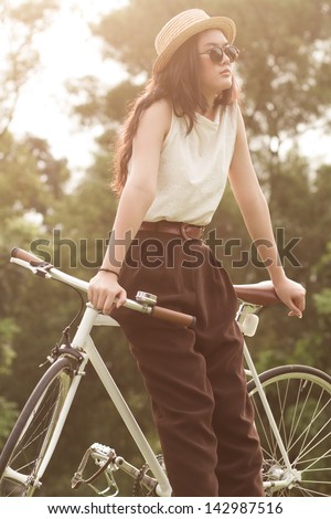 Woman sitting on her fixed gear bike.