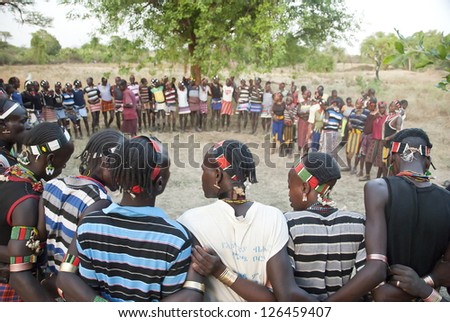 VALLEY OMO, ETHIOPIA - MARCH 12: Unidentified hamer men dance traditional dance at the festival dedicated to initiation rite for young men near Dimeka village, March 12, 2012 in Omo Valley, Ethiopia.