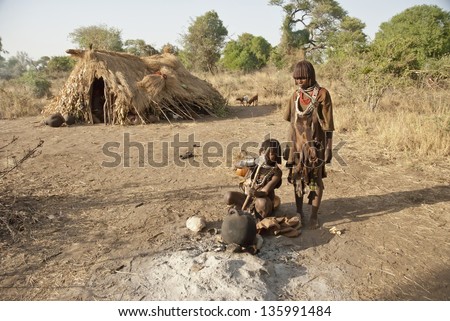 VALLEY OMO, ETHIOPIA - MARCH 12: Unidentified hamer women make traditional beer at the festival dedicated to initiation rite for young men near Dimeka village, March 12, 2012 in Omo Valley, Ethiopia.