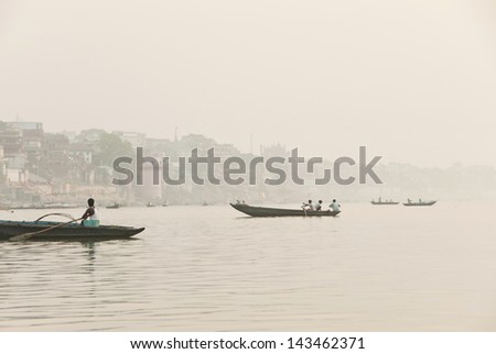 VARANASI, INDIA - APRIL 30: Unidentified Indian fishermen go fishing on the River Ganges in Varanasi, India on April 30, 2009. For most of dwellers fish is main source of livelihood.