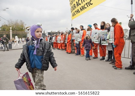 MOSCOW, RUSSIA - OCTOBER 5, 2013: Unidentified boy walks alone a row of supporters at the meeting in support of 30 Greenpeace activists charged with piracy, October 5, 2013 in Moscow, Russia.
