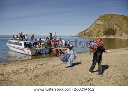 ISLA DEL SOL, BOLIVIA - MAY 12: Unidentified villagers go to shore on Isla del Sol, Lake Titicaca, Bolivia, May 12, 2010. Regular boat from Copacabana is only opportunity to stock up goods and food.