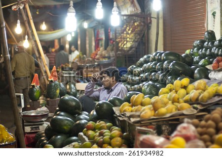 INDORE, INDIA - MARCH 7: Unidentified vendor sells fruits and vegetables at a street market in Indore, India, March 7, 2014. Indore is city in Madhya Pradesh, the largest agricultural state in India.