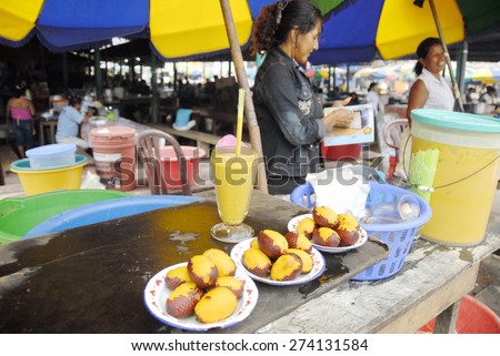 IQUITOS, PERU - APRIL 28: Unidentified woman sells juice of exotic fruit 