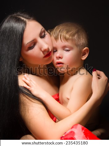Crying child in the embrace of mother