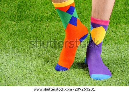 Colorful socks, green grass, men of foot