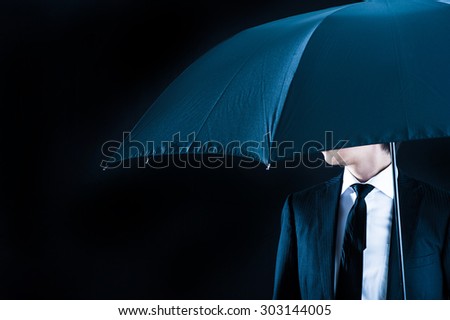 Umbrella and businessman, black background