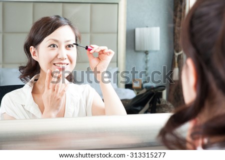 Women who have a makeup to look in the mirror