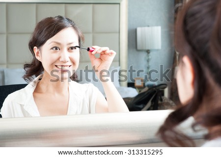 Women who have a makeup to look in the mirror