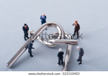 Wire puzzle, businessmen have a meeting