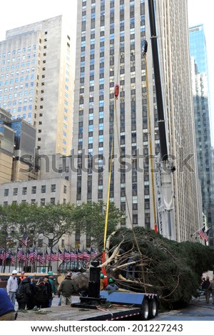 NEW YORK - NOVEMBER 12: The arrival and set up of the famous Rockefeller Center Christmas Tree in Rockefeller Center on November 12, 2010 in Manhattan, New York.