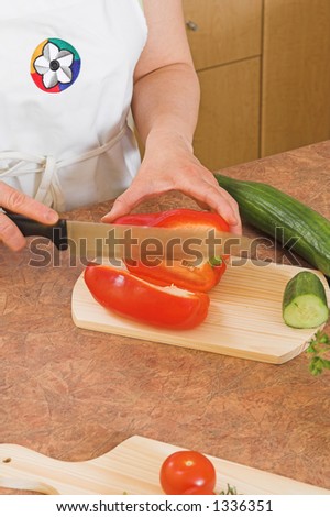 cutting cucumber on kitchen board