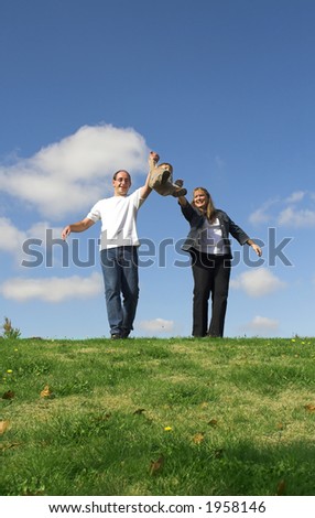 happy family making boy jump over blue sky