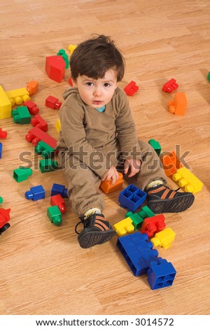 Similar – Image, Stock Photo Toddler seated on laminate floor; feet touch each other as legs splay out in open seated pose similar to butterfly pose in yoga