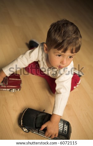 Similar – Image, Stock Photo Toddler seated on laminate floor; feet touch each other as legs splay out in open seated pose similar to butterfly pose in yoga