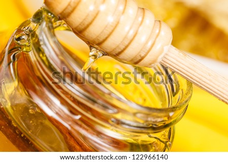 Pot of honey.Honey drip in jar on the table