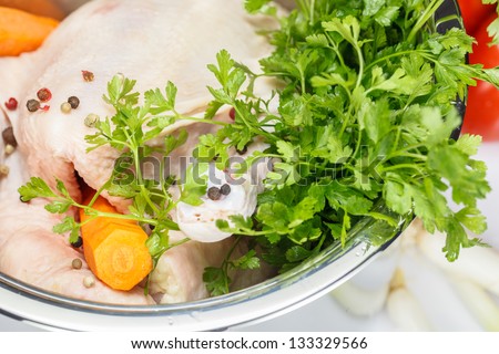 Chicken soup. Chicken and vegetables in pot, close up. Shallow depth of field