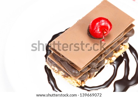 Chocolate cake. Chocolate cake with cherry on top on a white background