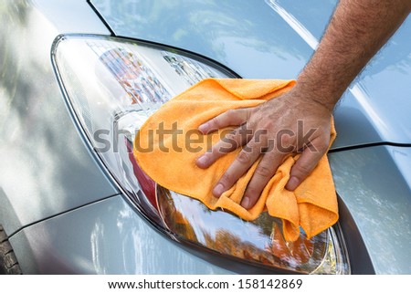 Cleaning the Car. Hand with microfiber cloth cleaning car, Close up