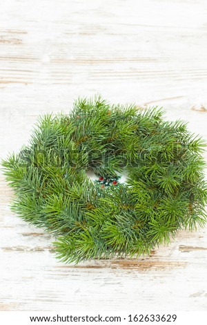 Christmas wreath over old wooden  background. Copy space composition
